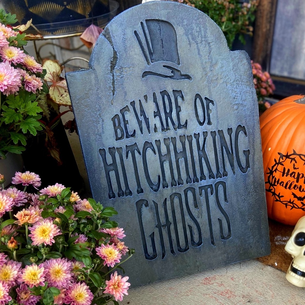 Tombstone.  BEWARE OF THE HITCHHIKING GHOSTS The haunted mansion